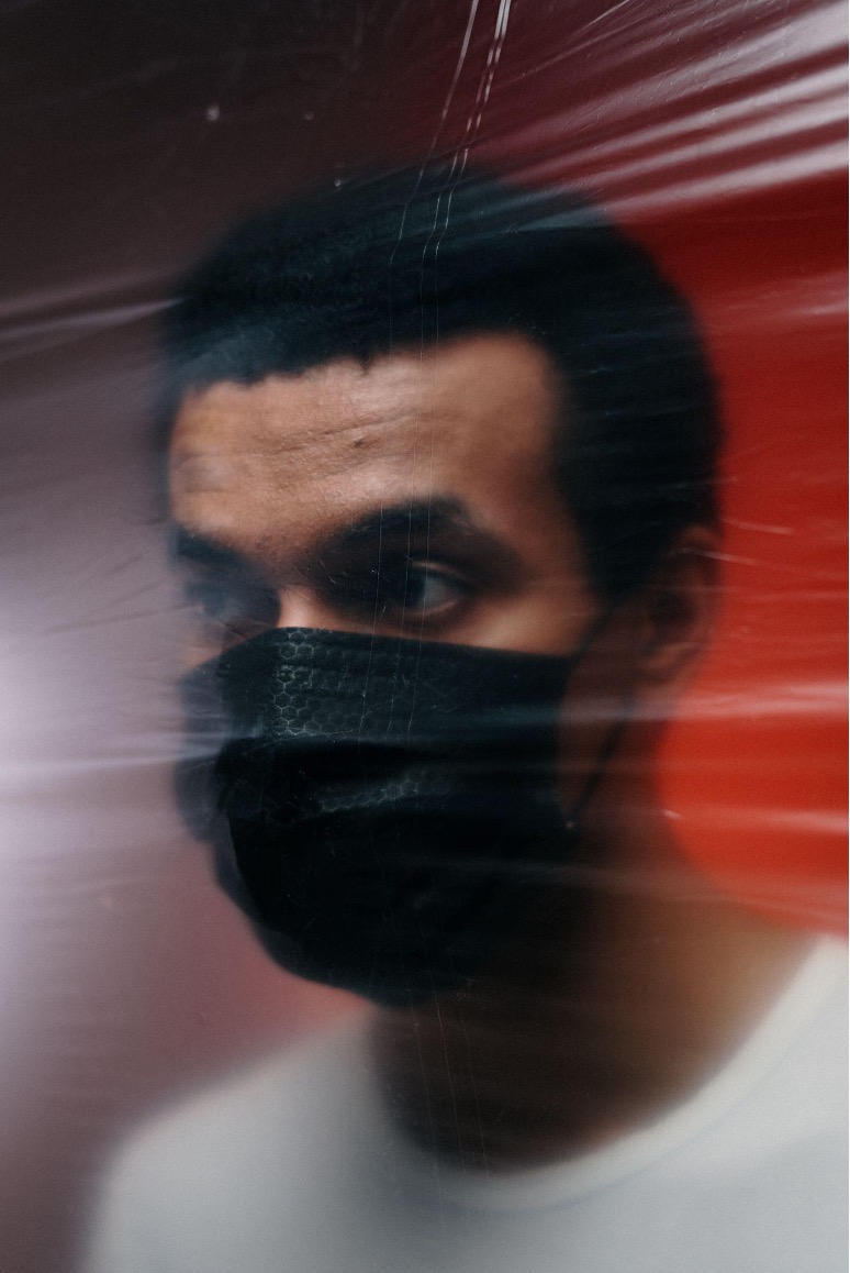 This is a blurry photo of a man wearing a mask.